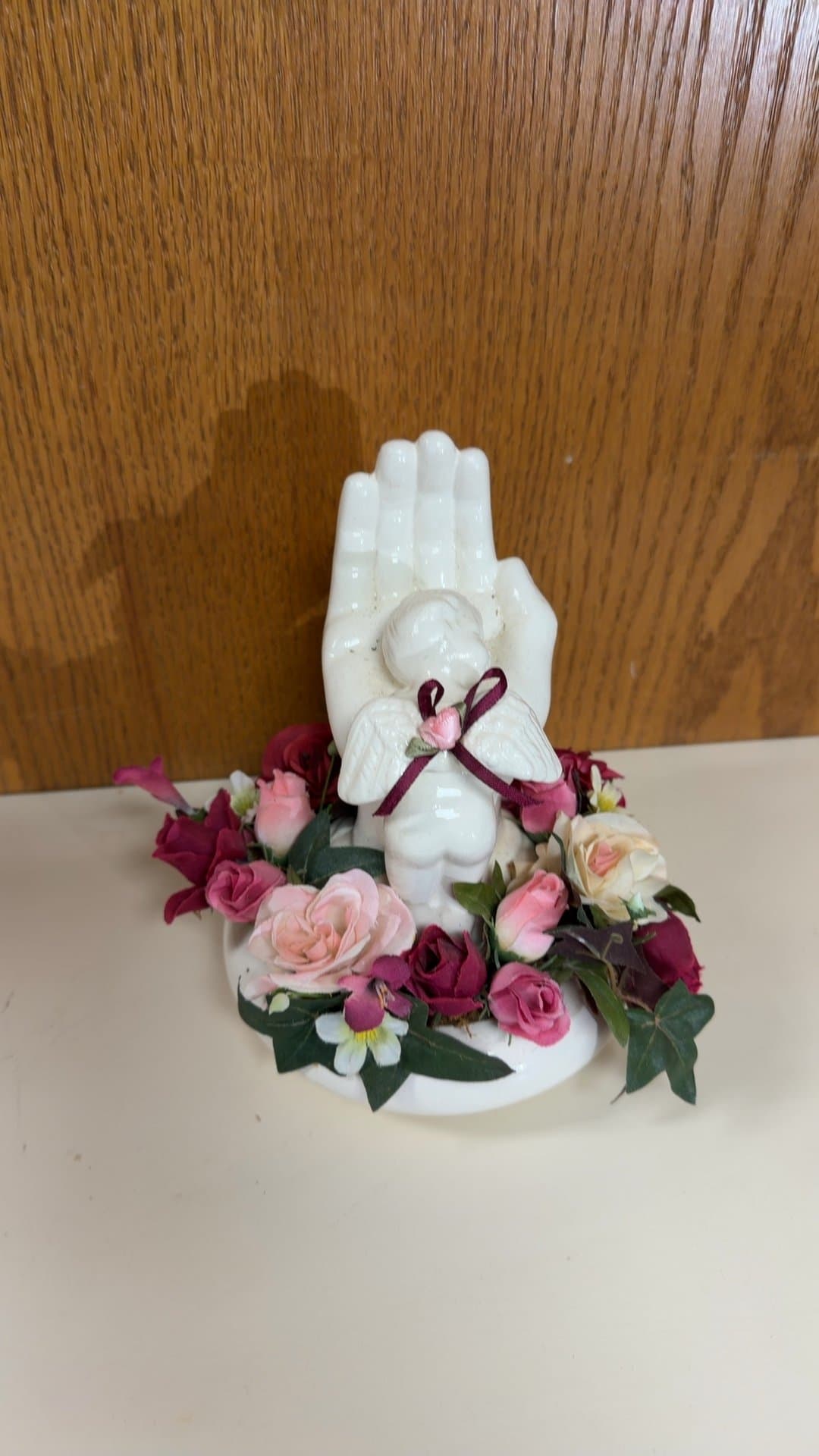 Porcelain Angel in Hand Figurine with Artificial Floral Base - Image 1