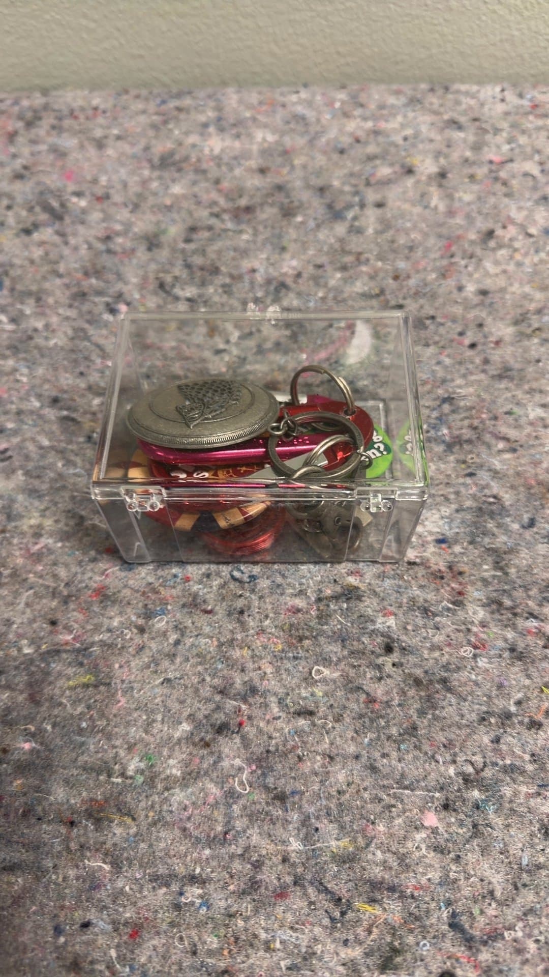 Assorted Keychains and Tokens in Clear Box - Image 1