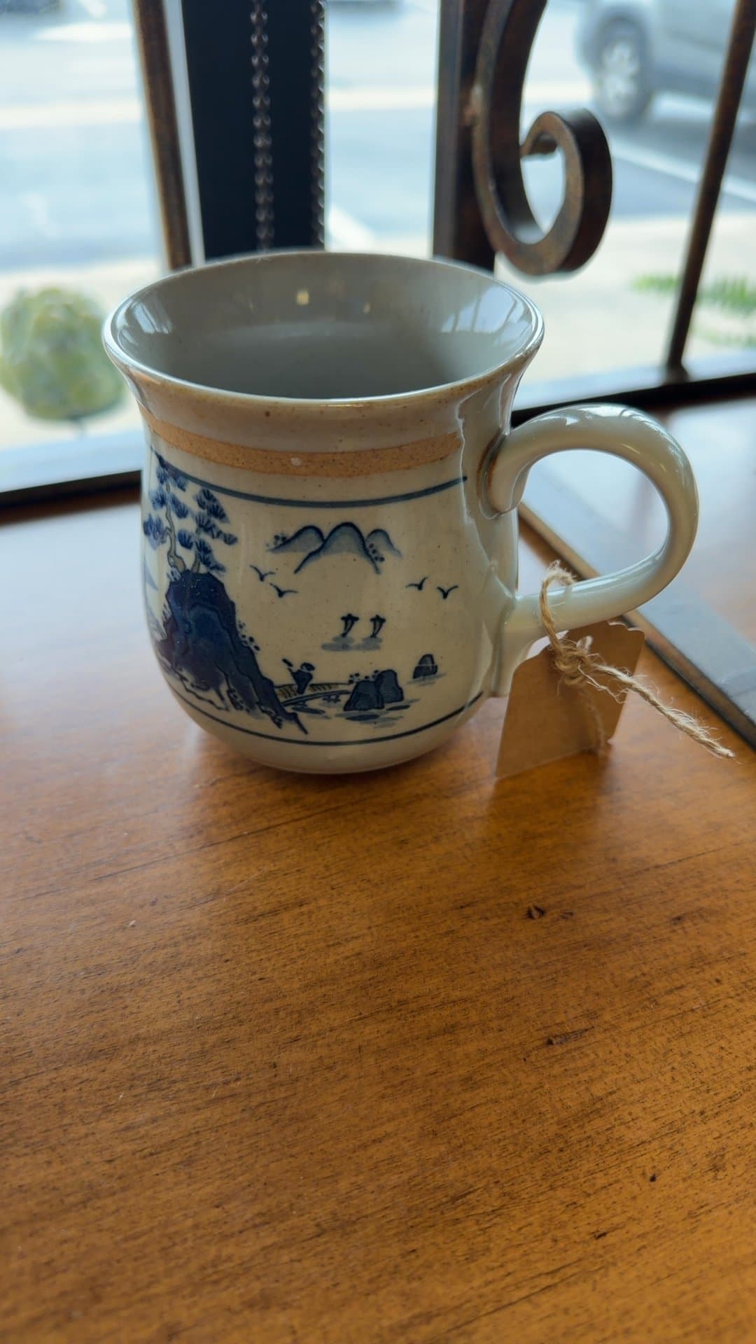 Blue and White Ceramic Mug with Landscape Design - Image 1
