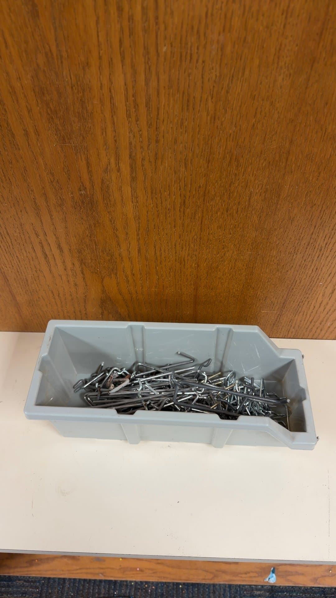 Assorted Pegboard Hooks in Storage Bin - Image 1